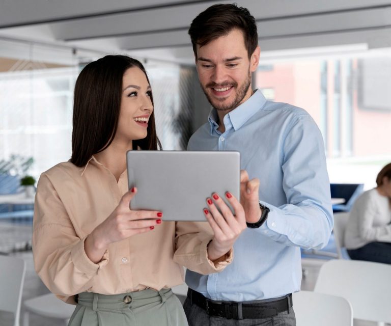 Man and woman holding tablet in office illustrates blog "What Is Business Property Insurance?"