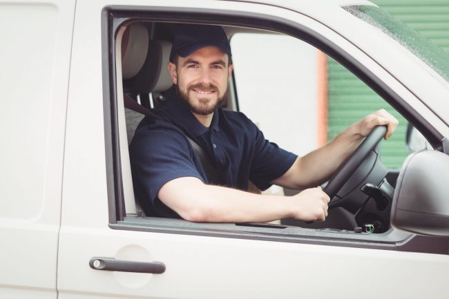 Man in a work van illustrates blog "What Is Commercial Auto Insurance?"