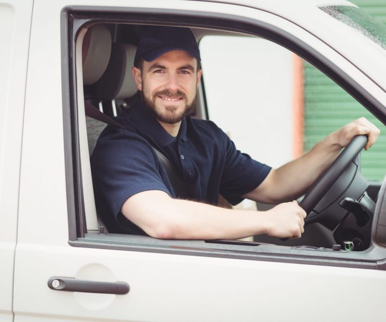 Man in a work van illustrates blog "What Is Commercial Auto Insurance?"