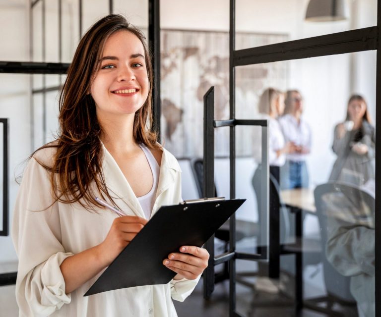 Professional woman holding clipboard illustrates blog "How Much Professional Liability Insurance Do I Need?"