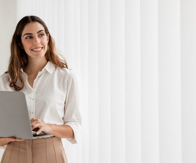 cyber-liability-insurance-FP Woman holding laptop illustrates blog "4 Reasons To Get Cyber Liability Insurance Today"