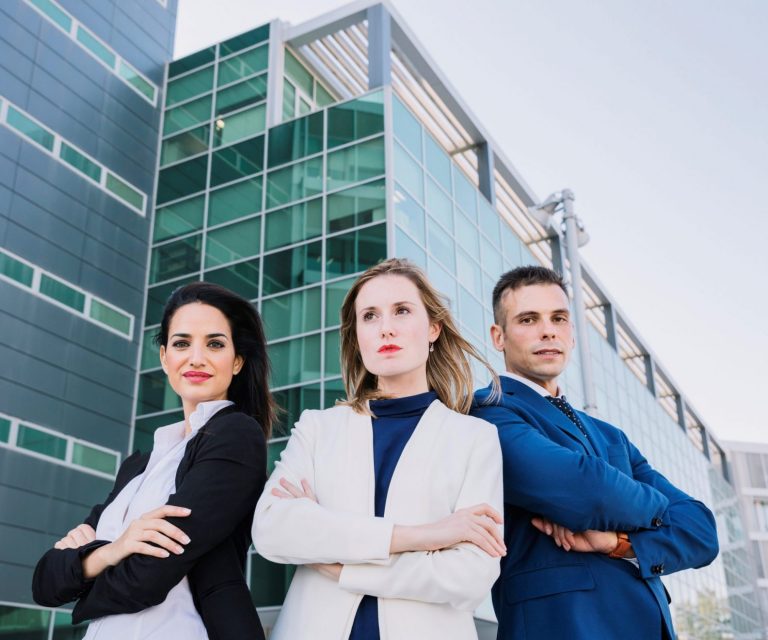 directors-officers-insurance A man and two women in business attire outside a building illustrate blog "Why Do Companies Need Directors and Officers Insurance?"