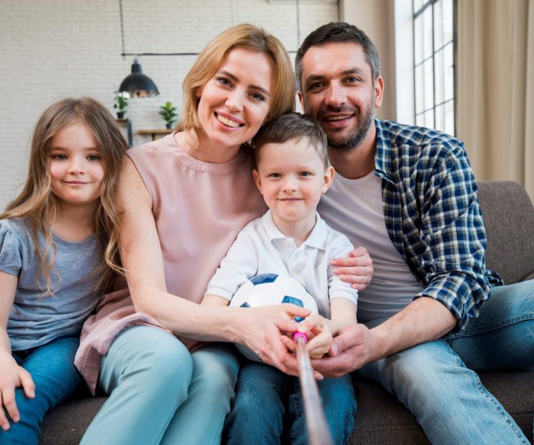 Family with parents and two children illustrates blog "Term Life Insurance: What You Need To Know"