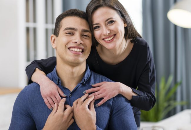 Woman with her hands on man's shoulders illustrates blog "What Is Whole Life Insurance?"