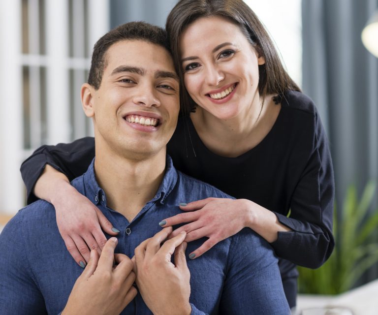 Woman with her hands on man's shoulders illustrates blog "What Is Whole Life Insurance?"