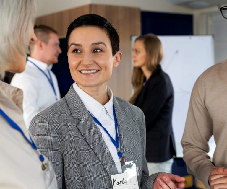 special-event-insurance-FP Photo of two women and a man in business attire and with name tags illustrate blog "How Does Special Event Insurance Work?"